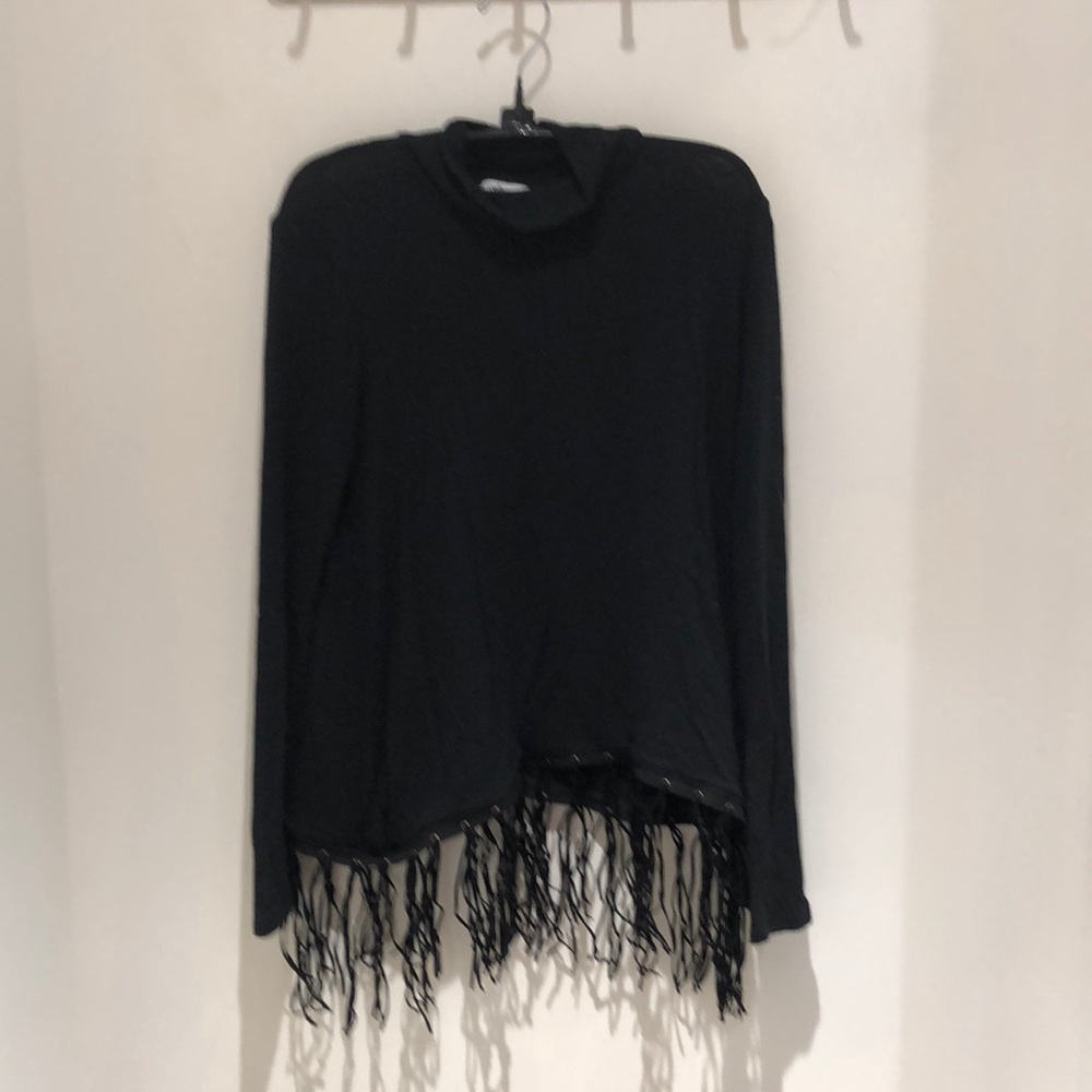 Red haute black mock-neck w/ fringe